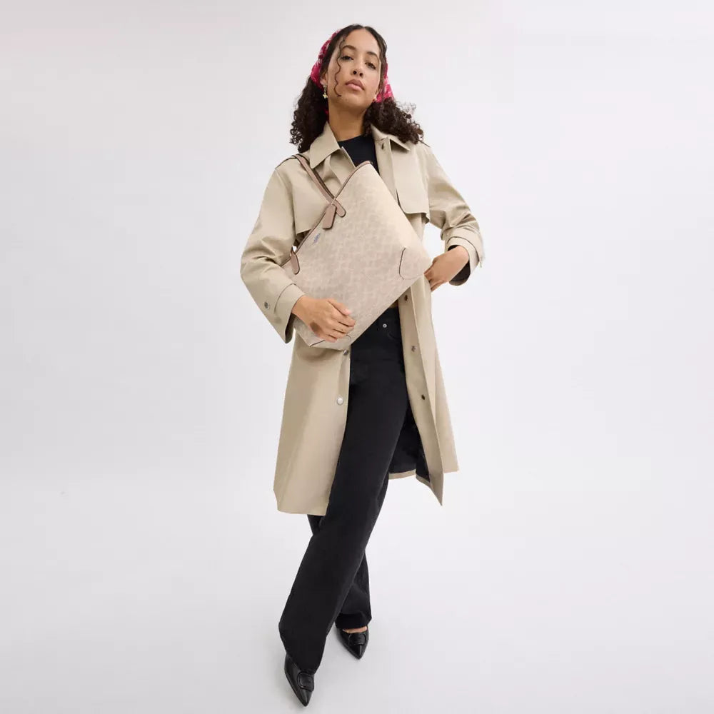 Neutral tote bag styled with a beige coat